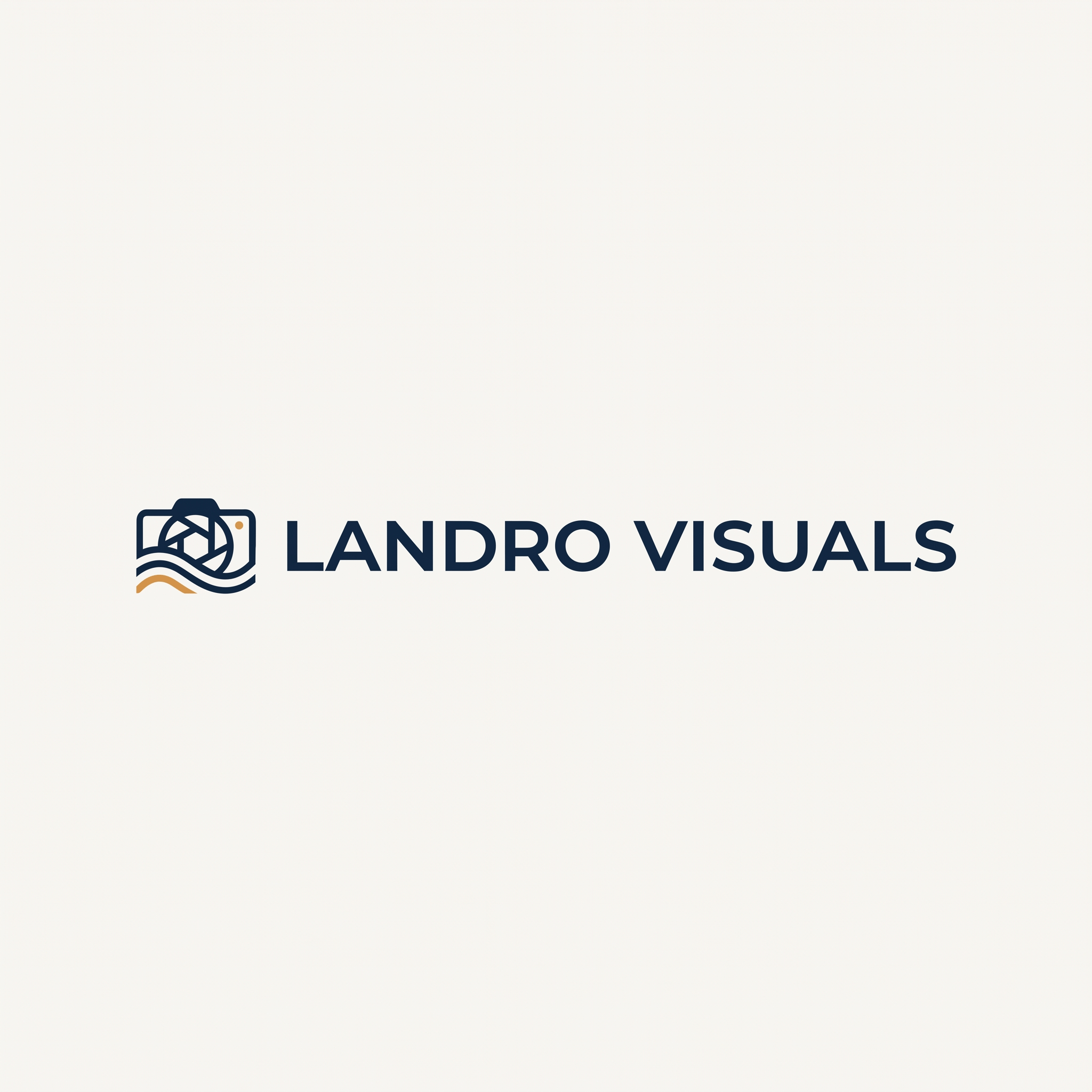 "Minimalist logo for a visual design studio called Landro Visuals, clean sans-serif wordmark with a subtle geometric accent, deep navy and warm amber on a soft off-white background, modern Scandinavian style, flat vector, high contrast, professional, no gradients, no shadows, centered composition, suitable for a website header with a small abstract mark combining a camera lens and a wave, placed to the left of the wordmark."
