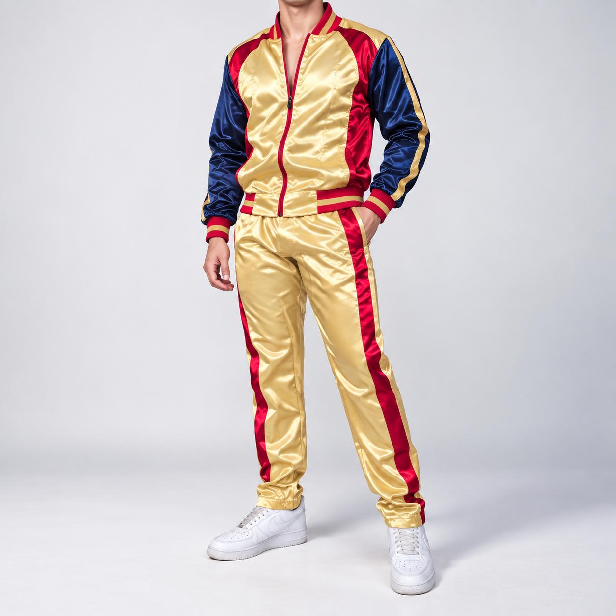 A premium, high-gloss satin track suit (2-piece jacket and pants set) in deep gold and navy blue with vibrant red accents[cite: 4]. The jacket body is brilliant gold satin, featuring contrasting navy blue sleeves with continuous gold and navy raglan stripes down the arms[cite: 4]. The front full zipper, ribbed stand-up collar, wrist cuffs, and bottom hem are lined with a distinct bold red stripe trim[cite: 4]. The matching pants are brilliant gold satin with continuous bold red side stripes down each leg, front pockets, and an elasticated waist[cite: 4].A professional studio portrait shot with clean, soft, even studio lighting. The background is a flawless, seamless neutral white studio wall. The male model is in a relaxed standing pose, three-quarter profile, with one hand casually placed in the front pants pocket and the other slightly bent, showcasing the drape and high sheen of the gold satin fabric. He is wearing clean, classic white sports sneakers[cite: 4]. **Crucially, the frame is tightly cropped at the base of the neck, revealing the model's neck and chin, but fully removing the face, eyes, and top of the head for a sophisticated and anonymized presentation.** He is wearing classic white sports sneakers. The focus is sharp on the satin details and stripe patterns.low resolution, low quality, pixelated, blurry, out of focus, distorted, artifacted, jagged edges, compressed, dull fabric, matte fabric, modifications to the design, full face visible, eyes visible, top of head visible, hair, facial expression, different fabric type, added logos, missing red side stripes, incorrect fit, incorrect colors (outside of gold, navy, red, white).